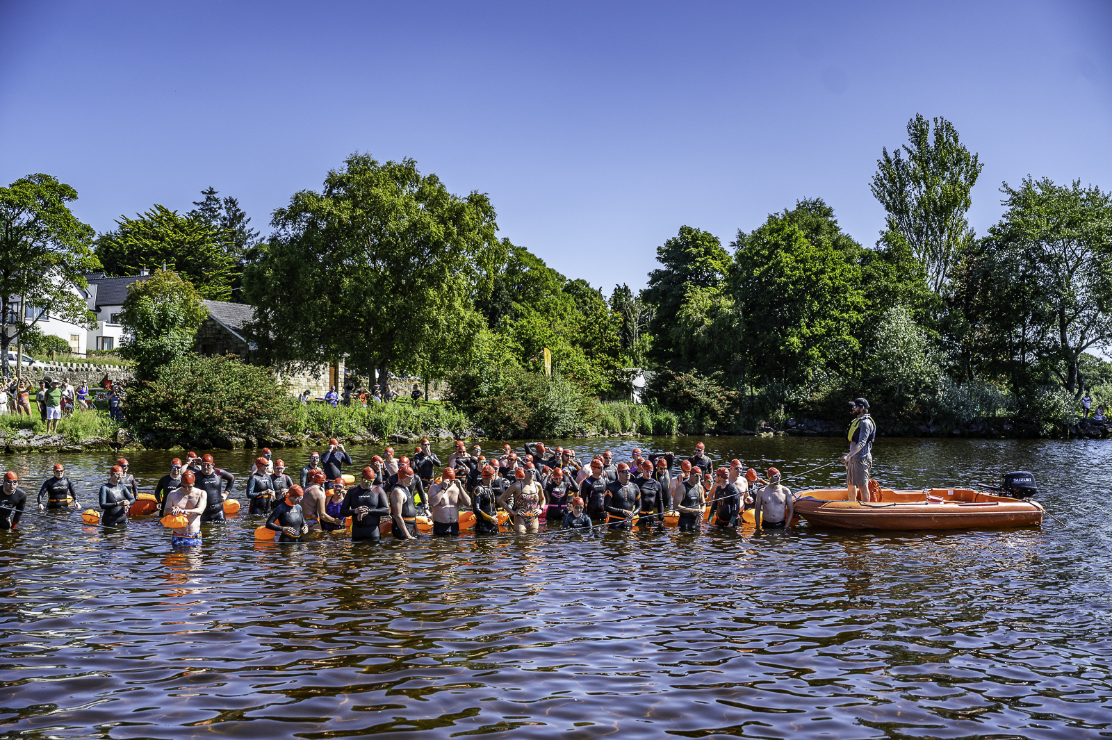 Open water swimmers entering the lake for a freshwater swimming event in Ireland